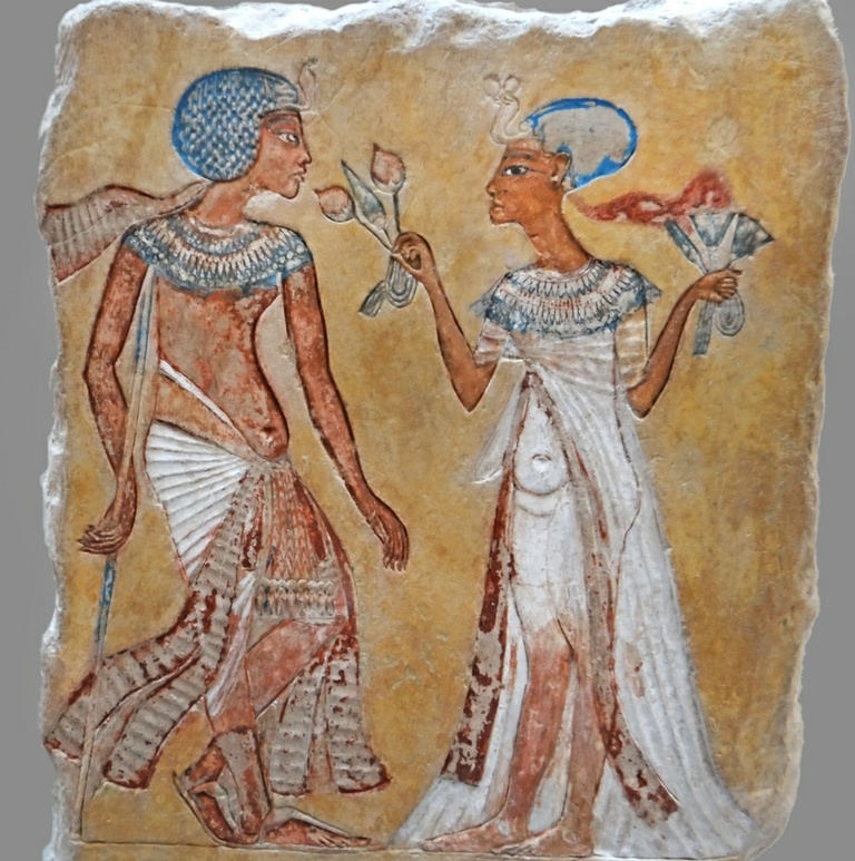 Royal Couple (Pharaoh Smenkhkare and Queen) in a garden holding mandrake flowers. 18th Dynasty. Amarna Period (ca. 1350-1340 BCE). Painted limestone. 24.8cm tall. Neues Museum, Berlin. Photo credit: ArchaiOptix.